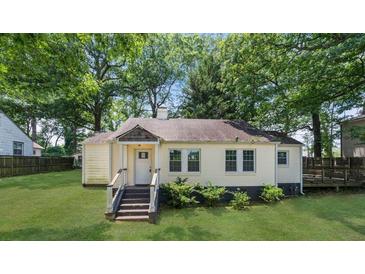 Quaint single-story home featuring a well-manicured lawn and mature trees at 1472 Norman Berry Dr, Atlanta, GA 30344