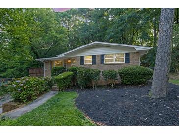 Charming brick home with mature trees, well-maintained landscaping, and inviting facade at 2286 Capehart Ne Cir, Atlanta, GA 30345
