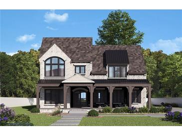 Charming two-story home with beautiful white brick, a covered porch, and lush landscaping at 245 Heatherton Way, Milton, GA 30009