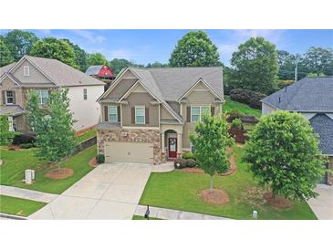 Charming two-story home with stone accents, a well-manicured lawn, and mature trees in a desirable neighborhood at 2325 Lake Cove Ct, Buford, GA 30519