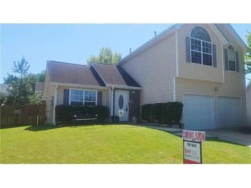 Charming two-story home with a well-manicured lawn and a two-car garage at 116 Ventura Trl, Stockbridge, GA 30281