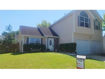 Charming two-story home with a well-maintained lawn and a two-car garage, perfect for a growing Gathering at 116 Ventura Trl, Stockbridge, GA 30281