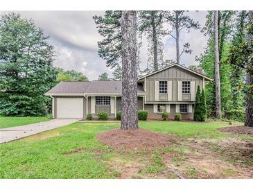 Charming home with a well-maintained front yard and attached one car garage at 2110 Redbud Sw Ct, Marietta, GA 30008