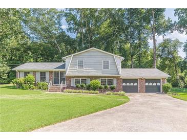 Charming home featuring a well-manicured lawn and a two-car garage at 3109 Albatross Ln, Decatur, GA 30034