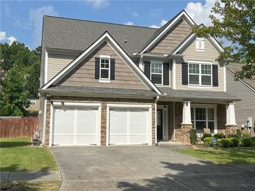 Charming two-story home with a stone-accented facade and a spacious two-car garage at 2481 Southhaven Ln, Buford, GA 30519