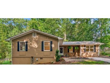 Charming single-Gathering home with a quaint front yard and dark shutters, nestled in a lush, green neighborhood at 364 Stafford Sw St, Marietta, GA 30064