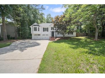 Charming two-story home with a well-manicured lawn and a two-car garage at 990 Trestle Dr, Austell, GA 30106