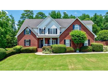 Charming brick home with well-manicured lawn and mature landscaping at 4167 Alayna Lee Cir, Mcdonough, GA 30252