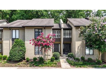 Charming townhome exterior featuring pink crape myrtle trees and lush landscaping at 12 Ivy Ne Rdg, Atlanta, GA 30342