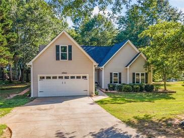 Charming home featuring a two-car garage and a well-maintained lawn, nestled among mature trees at 3540 Pilgrim Mill Rd, Cumming, GA 30041