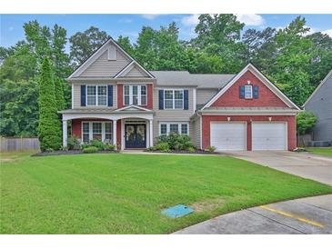 Charming two-story home boasts a brick and siding facade, lush lawn, and attached two-car garage at 1019 Avonley Creek Trce, Sugar Hill, GA 30518