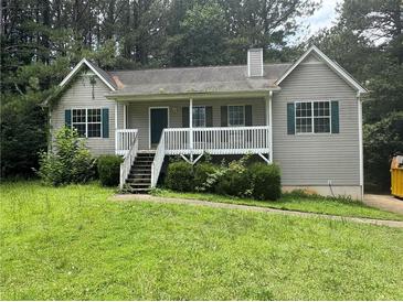 A charming single-Gathering home featuring a quaint front porch and neatly landscaped front yard at 1 Thorntree Pass, Powder Springs, GA 30127