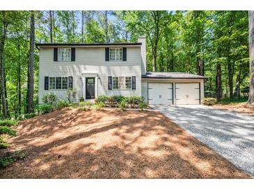 Traditional two-story home featuring a two-car garage and a well-manicured front yard at 2136 N Landing Way, Marietta, GA 30066