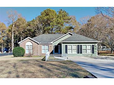Charming home with a brick and siding exterior, complemented by a well-maintained lawn at 2082 Blackberry Ln, Auburn, GA 30011