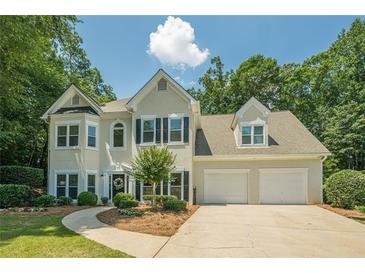 Traditional two-story home featuring a two-car garage and manicured front lawn at 3275 Cherry Oak Ln, Cumming, GA 30041