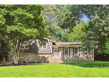 Charming brick and wood home with a well-manicured lawn and mature trees in a peaceful setting at 5510 Stoneybrook Se Ct, Mableton, GA 30126