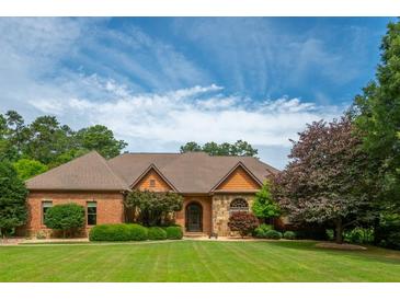 Beautiful single-story brick home with lush green lawn and mature trees at 3505 Watson Rd, Cumming, GA 30028