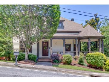 Charming two-story home featuring a welcoming front porch and lush landscaping for enhanced curb appeal at 260 W Peachtree St, Norcross, GA 30071