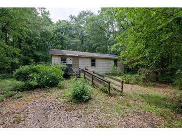 Exterior view of the property showcasing the facade and surrounding landscape at 400 Mccart Rd, Mcdonough, GA 30252