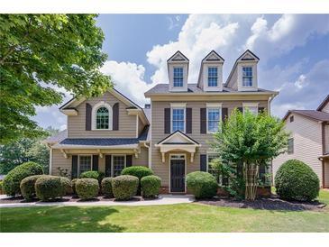 Charming two-story home with a manicured lawn and symmetrical landscaping at 115 Dunlavin Dr, Acworth, GA 30102