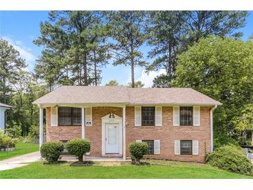 Charming brick home features a well-maintained lawn and classic architectural details at 4133 Conley Circle Cir, Conley, GA 30288