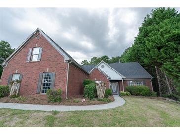 Charming single-Gathering home with brick exterior, manicured lawn and a welcoming walkway at 1200 Martins Chapel Se Ln, Lawrenceville, GA 30045