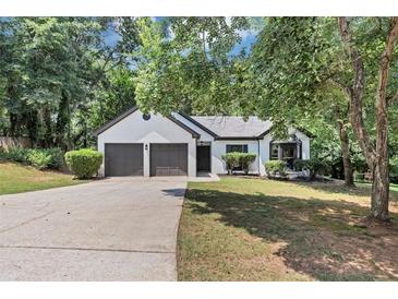 Charming one-story home with a two-car garage and well-maintained front yard at 3021 Stone Bridge Sw Trl, Conyers, GA 30094