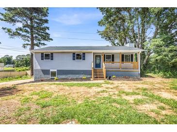 Charming single-story home with a covered front porch and freshly landscaped front yard at 6607 Forestdale Ln, Douglasville, GA 30135