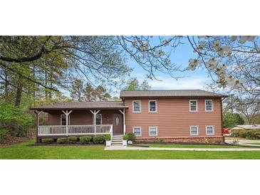 Charming two-story home with a covered porch and well-maintained lawn at 3916 S Martin Way, Lithia Springs, GA 30122