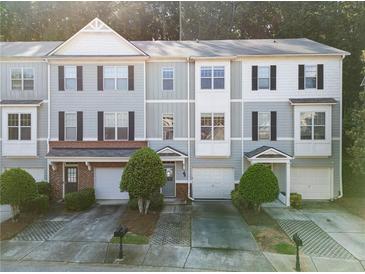Charming townhome featuring a well-manicured lawn and a convenient one-car garage at 1768 Oakbrook Nw Ln # 9, Kennesaw, GA 30152