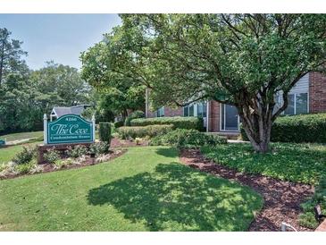 Well-maintained condominium complex entrance with mature landscaping and signage for The Cove Condominium Homes at 4266 Roswell Ne Rd # H4, Atlanta, GA 30342