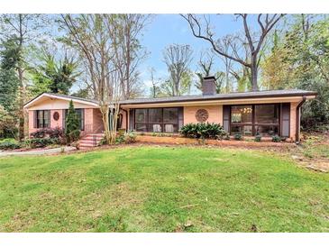 Charming single-story brick home with a lush green lawn and mature trees in a desirable neighborhood at 2994 Baker Ridge Nw Dr, Atlanta, GA 30318
