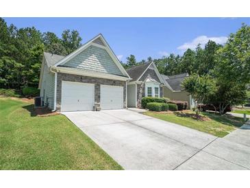 Charming single-Gathering home with a two-car garage and well-maintained landscaping at 1856 Temple Park Dr, Loganville, GA 30052