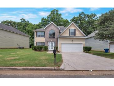 Charming two-story home featuring a well-maintained lawn and a two-car garage at 2210 Benidorm Ct, South Fulton, GA 30349