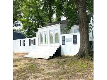 Charming home featuring a well-kept yard, prominent tree, and a welcoming entryway at 546 Hamilton E Holmes Drive Northwest, Atlanta, GA 30318