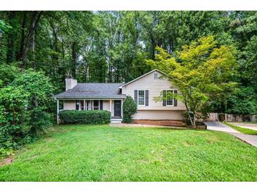 Charming single-Gathering home with a well-manicured lawn and mature trees at 1131 Hershey Dr, Marietta, GA 30062