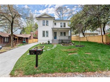 Charming two-story home with a well-manicured lawn, beautiful landscaping, and inviting front porch at 779-A Lynwood Se St, Atlanta, GA 30312