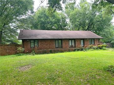 Ranch-style home featuring a brick facade, large yard and mature trees at 2641 Old Norcross Rd, Tucker, GA 30084
