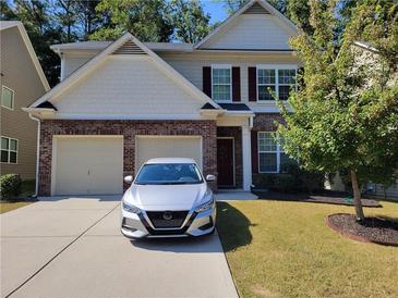 Charming two-story home featuring a two-car garage, brick accents, and well-maintained landscaping at 3020 Ben Blvd, Austell, GA 30106