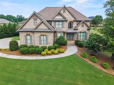 Beautiful brick home with manicured lawn, mature trees, and meticulous landscaping at 2602 Alcovy Club Dr, Dacula, GA 30019