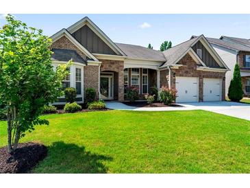 Charming single-story home with a brick facade, manicured lawn, and attached two-car garage at 2844 Bluestone Sw Dr, Atlanta, GA 30331