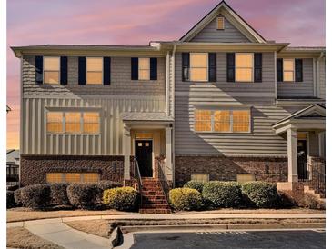 Charming townhome with gray siding, brick accents, black shutters, and manicured landscaping at 3898 High Dove Sw Way # 12, Smyrna, GA 30082