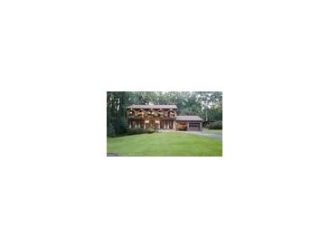 Charming two-story home with landscaped yard, brick facade, and unique arched balcony at 4567 Town Crier Sw Rd, Lilburn, GA 30047