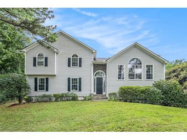 Charming home with white siding, dark shutters, and a well-manicured lawn at 304 Bennett Farms Ct, Acworth, GA 30102