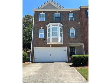 Charming two-story brick home with an attached two car garage and well maintained landscaping at 4210 Chatham Ridge Drive Dr, Buford, GA 30518