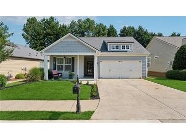 Charming single-Gathering home featuring a well-manicured lawn, a two-car garage, and welcoming front porch at 507 Bonneset Ct, Canton, GA 30114