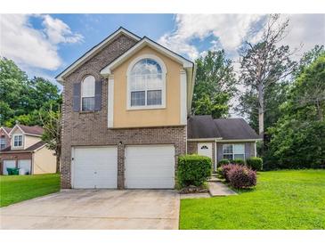 Charming two-story home with a two-car garage and well-maintained lawn at 6207 Idlewood Cir, Lithonia, GA 30038