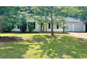 Charming single-story home with attached two-car garage, covered front porch, and a well-maintained lawn at 298 Thorn Thicket Dr, Rockmart, GA 30153