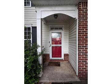 Inviting front entrance with a red door, brick accents, and traditional design elements at 4018 Carisbrook Dr, Union City, GA 30291