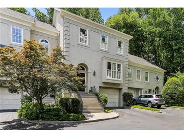 Stunning two-story home boasts beautiful architectural details and a well-manicured front yard at 2466 Brookhaven Ne Pl, Brookhaven, GA 30319